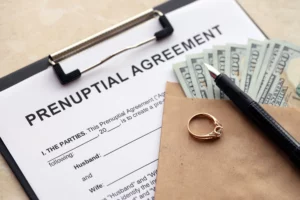 Prenuptial agreement with money and ring, symbolizing financial planning before marriage.