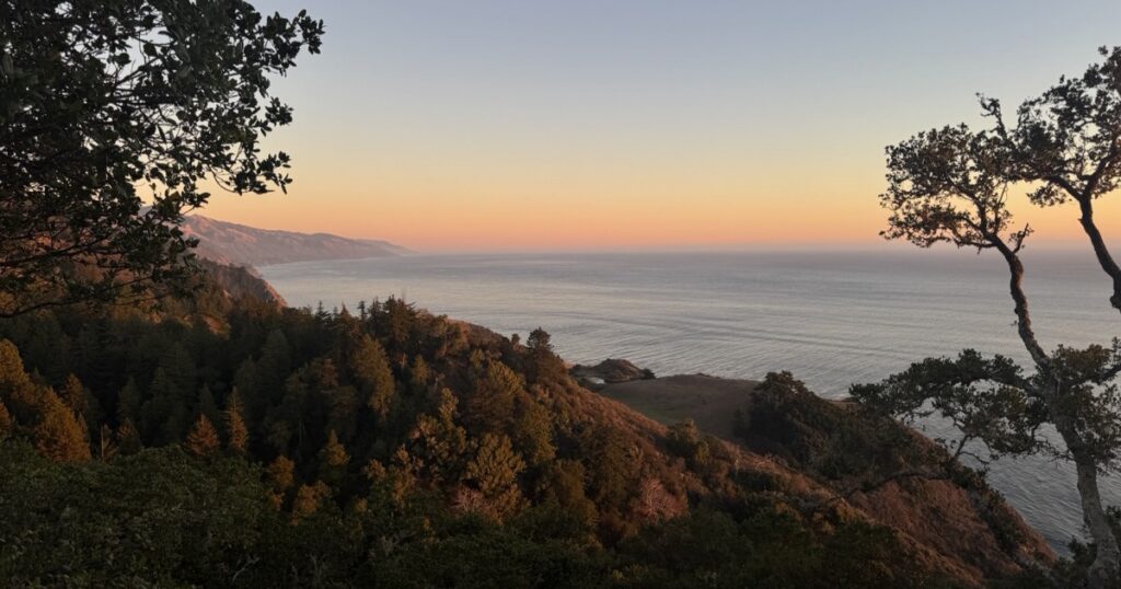 Sunset over the Pacific Ocean from a coastal ridge